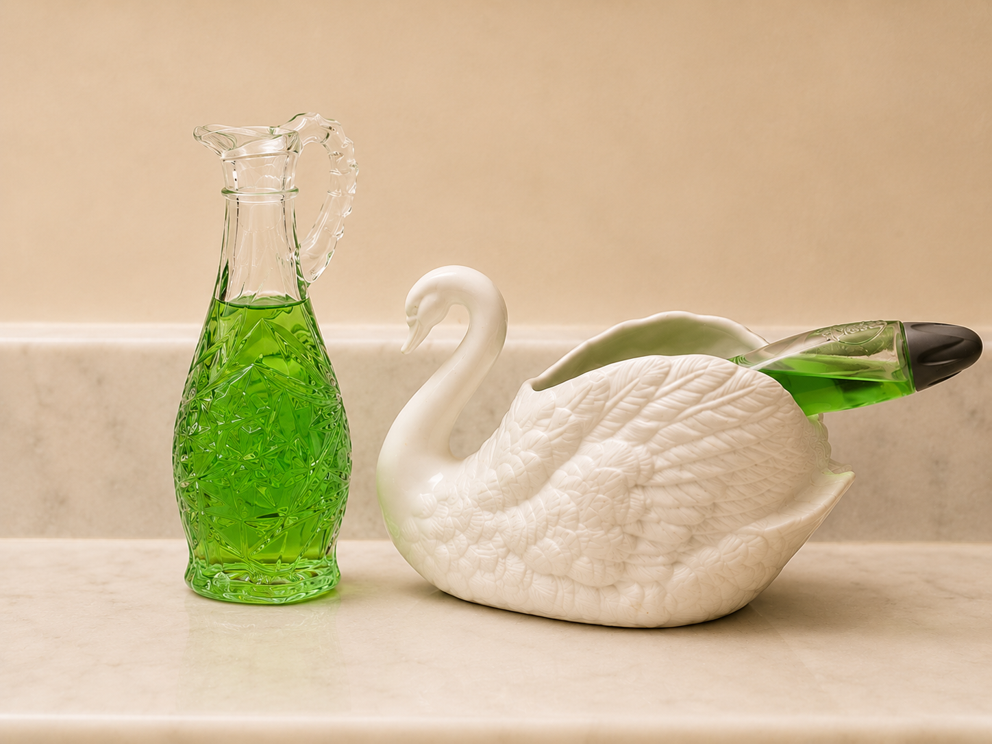 White ceramic swan dish and green glass bottle with dish soap on a marble surface